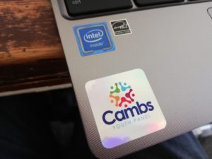 Close up photo of a laptop device with a Cambs Youth Panel sticker on 