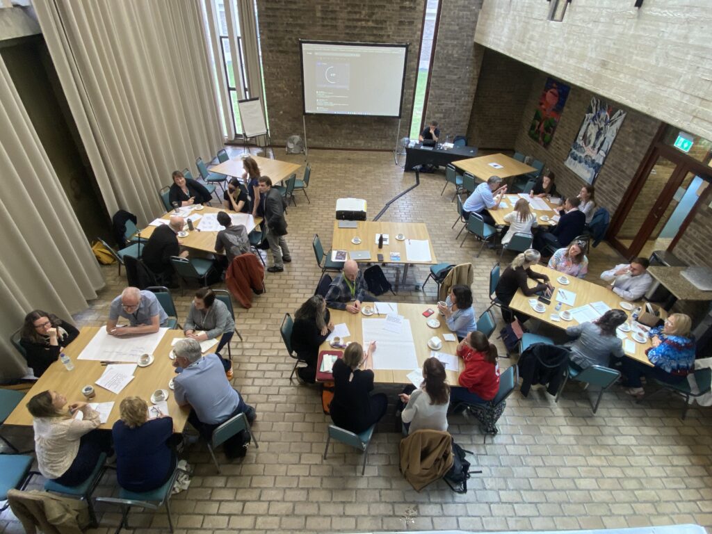 Birdseye view of people having discussions around tables.