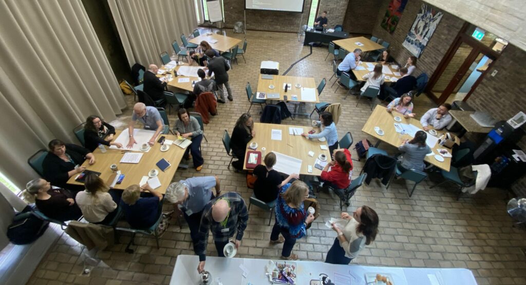 Lots of people sat around tables at a networking event